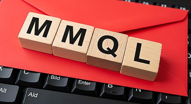 Wooden blocks spelling MMQL resting on a vibrant red envelope and a black computer keyboard symbolizing marketing qualified leads in a modern business environment conveying efficiency and success photo
