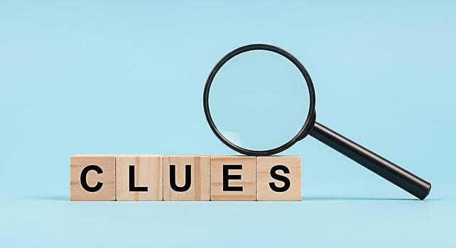 Magnifying glass examining wooden blocks spelling CLUES on a light blue background representing investigation problemsolving and the search for answers with a sense of mystery and intrigue photo