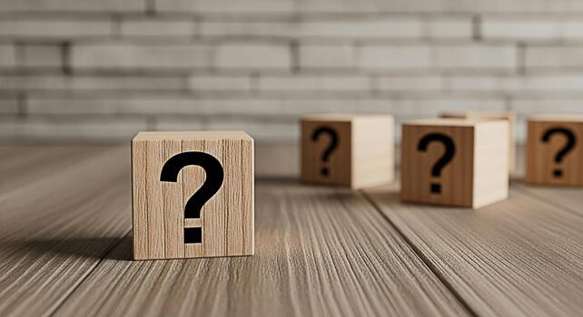Wooden blocks displaying question marks on a wooden surface against a brick wall symbolizing uncertainty confusion and the search for answers in a complex and challenging environment photo