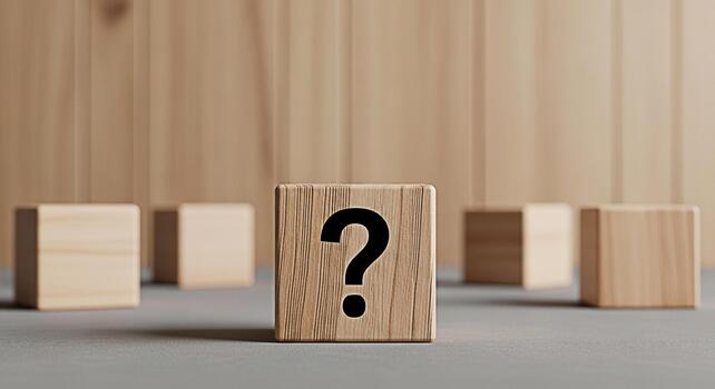 Wooden block displaying a question mark symbol on a neutral surface surrounded by other blocks creating a sense of uncertainty and curiosity in a minimalist studio setting perfect for conceptual illus photo