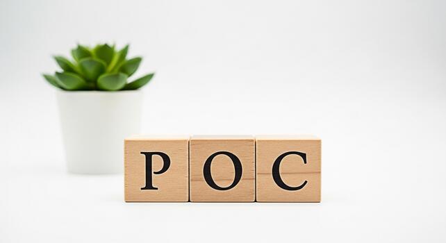 Wooden blocks displaying POC on a white surface next to a succulent symbolizing proof of concept in a clean and minimalist setting conveying innovation and validation with a touch of natural elegance photo