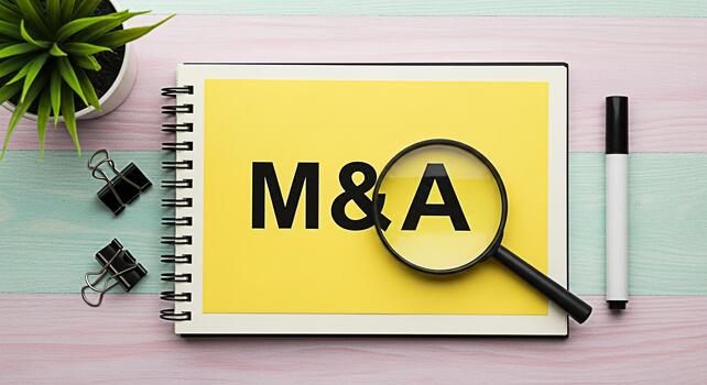 Closeup of MA Mergers and Acquisitions text on a yellow notepad with a magnifying glass symbolizing due diligence and strategic planning in a business environment conveying a sense of analysis and opp photo