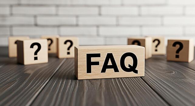 Wooden blocks displaying FAQ and question marks on a dark wooden table against a white brick wall representing information support and problemsolving in a clear and concise manner photo