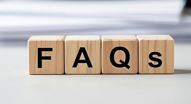 Wooden blocks displaying FAQs on a neutral surface representing frequently asked questions in a simple and informative way ideal for business and customer service concepts photo