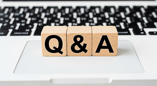 Wooden blocks displaying Q A on a laptop keyboard representing questions and answers knowledge sharing and information exchange in a digital learning environment fostering understanding and problemsol photo