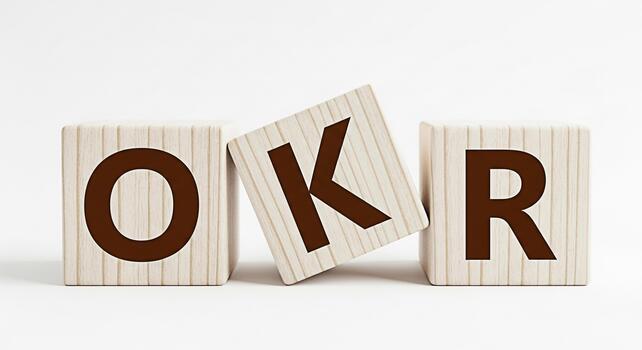 Wooden blocks spelling out OKR on a white surface representing objectives and key results in a minimalist setting conveying a sense of focus and strategic planning for business success photo