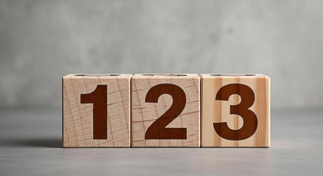 Wooden blocks displaying the numbers one two and three on a gray surface symbolizing learning and development in an educational setting with a focus on early childhood and foundational skills photo