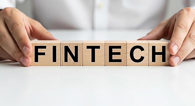 Hands arranging wooden blocks spelling FINTECH on a white surface symbolizing innovation and technology in finance representing the future of financial services and digital transformation in a modern photo