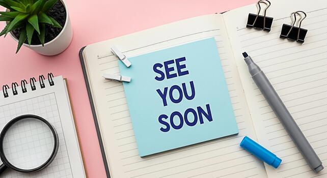 Office desk setup with a blue sticky note saying See You Soon placed on an open notebook conveying a message of anticipation and farewell in a modern and organized workspace perfect for business or pe photo