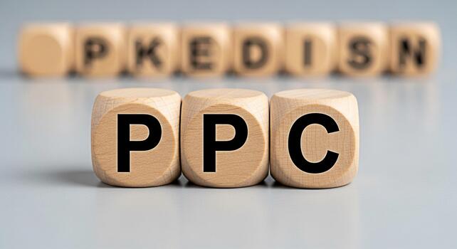 Wooden blocks displaying PPC on a gray surface representing pay per click advertising and digital marketing strategies for online business growth and successful campaigns emphasizing cost effectivenes photo
