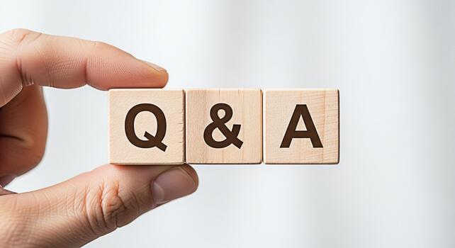Hand holding wooden blocks displaying Q A on a clean white background representing questions and answers knowledge sharing and interactive communication in a clear and concise manner photo