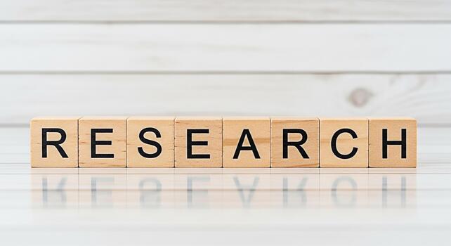 Wooden blocks spelling RESEARCH on a white surface symbolizing investigation analysis and the pursuit of knowledge in an academic or professional setting conveying a sense of discovery and innovation photo