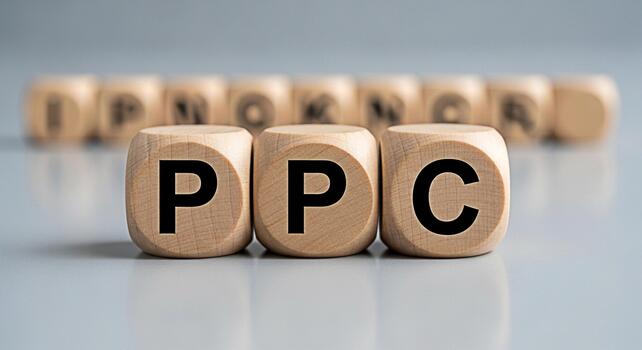 Wooden blocks displaying PPC on a gray surface representing payperclick advertising in a business setting symbolizing online marketing strategies and costeffective advertising solutions photo