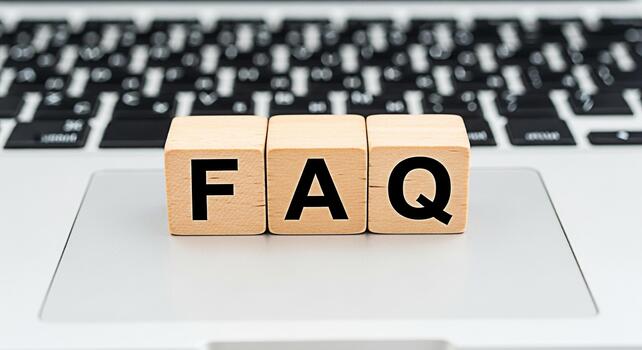 Wooden blocks displaying FAQ on a laptop keyboard representing frequently asked questions and providing information creating a helpful and informative online environment for users seeking answers photo