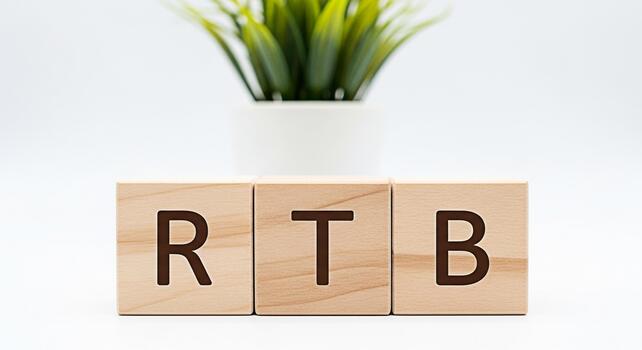 Wooden blocks displaying RTB on a white surface with a potted plant symbolizing RealTime Bidding in a clean minimalist setting conveying a message of efficiency and modern advertising solutions photo