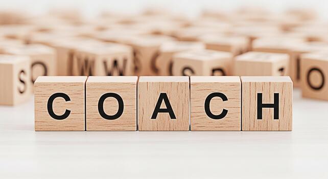 Wooden blocks spelling COACH on a white surface representing guidance and mentorship in a learning environment fostering personal and professional development with a supportive and motivational mood photo
