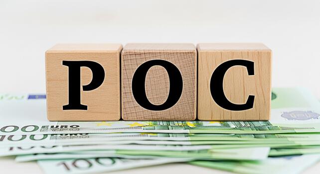 Wooden blocks spelling POC resting on a stack of Euro banknotes symbolizing proof of concept in a financial setting representing business validation and investment potential with a clean bright backgr photo