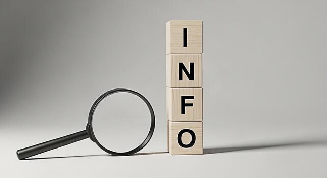 Magnifying glass examining wooden blocks spelling out INFO in a neutral setting representing information discovery research and the importance of data analysis for informed decisionmaking photo