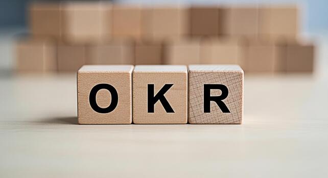 Wooden blocks spelling OKR on a table representing Objectives and Key Results in a business setting symbolizing goal setting and strategic planning for success and achievement photo