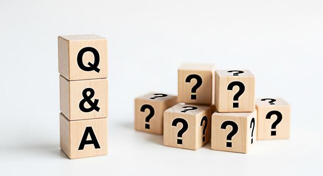 Wooden blocks displaying QA and question marks on a white surface representing uncertainty and the search for answers in a clean minimalist setting symbolizing knowledge and problemsolving photo