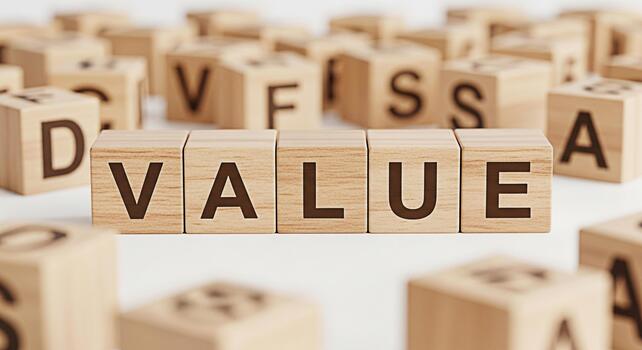 Wooden blocks spelling VALUE on a white surface surrounded by other lettered blocks symbolizing importance and worth in a business or personal development context creating a positive and motivational photo