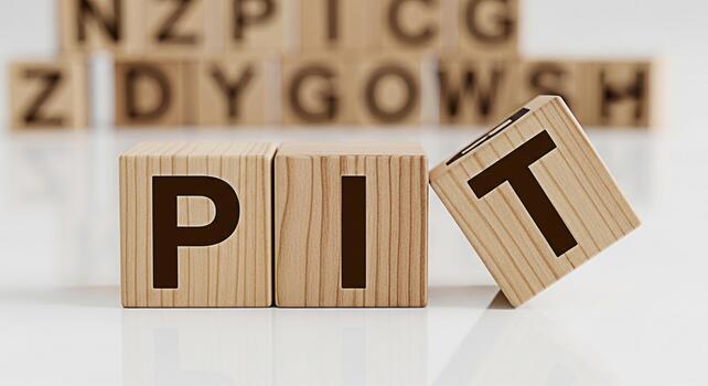 Wooden blocks spelling PIT with a T block falling symbolizing challenges and adversity on a reflective surface conveying a sense of difficulty and potential failure in a business context photo