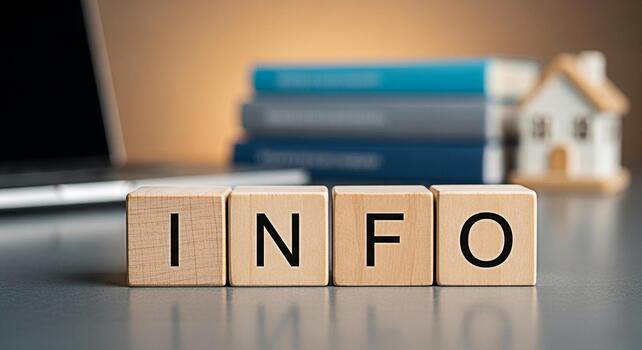 Wooden blocks spelling INFO on a desk with a laptop and books representing information and knowledge in a home office environment conveying a sense of learning and productivity photo