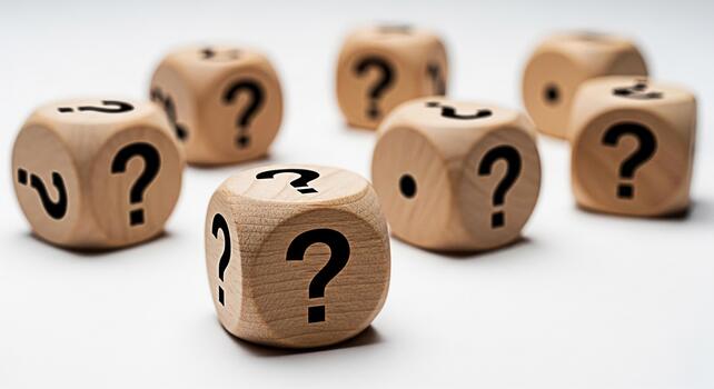 Wooden dice displaying question marks on a white surface representing uncertainty and the need for answers in a business or educational context creating a sense of curiosity and challenge photo
