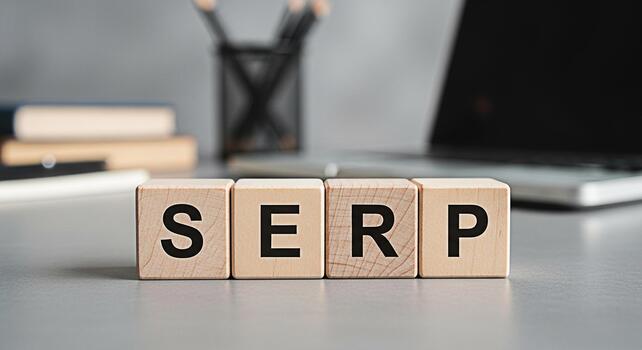 Wooden blocks spelling SERP on a desk in a modern office representing search engine results page optimization and the importance of online visibility for business success in the digital marketing land photo