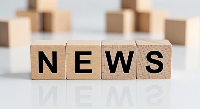 Wooden blocks spelling NEWS on a white surface reflecting the letters conveying a message of information updates and current events in a clean and minimalist setting perfect for media and communicatio photo