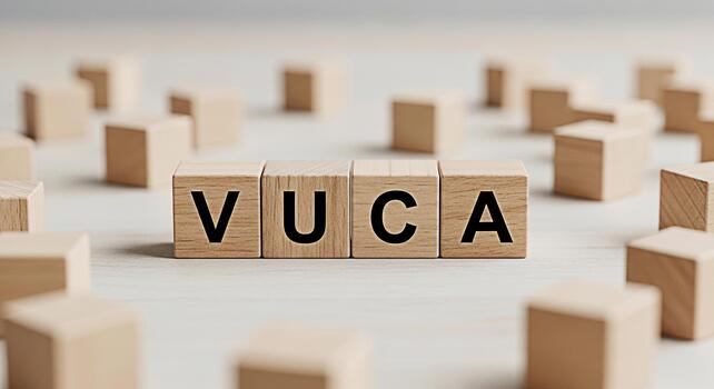 Wooden blocks spelling VUCA on a bright wooden surface representing Volatility Uncertainty Complexity and Ambiguity in business strategy and leadership in a constantly changing environment photo