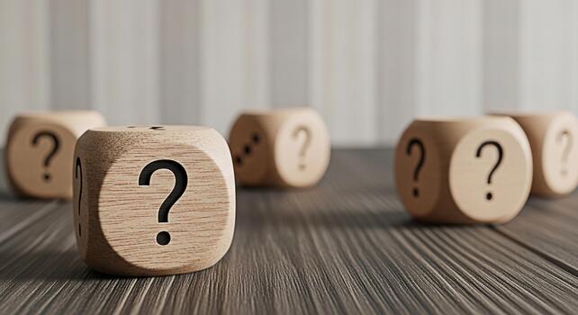 Wooden dice displaying question marks resting on a textured wood surface symbolizing uncertainty and the need for answers in a business or personal context creating a mood of contemplation and problem photo