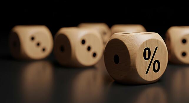 Wooden dice displaying a percentage symbol on a reflective surface in a dark studio setting conveying concepts of risk chance and financial decisions with a focus on interest rates and investment oppo photo