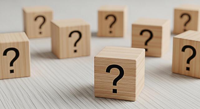 Wooden blocks displaying question marks on a textured surface symbolizing uncertainty and the need for answers in a complex situation fostering curiosity and problemsolving skills photo