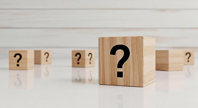 Wooden blocks displaying question marks on a reflective surface against a white wood panel background symbolizing uncertainty inquiry and the search for answers in a clean and minimalist setting photo