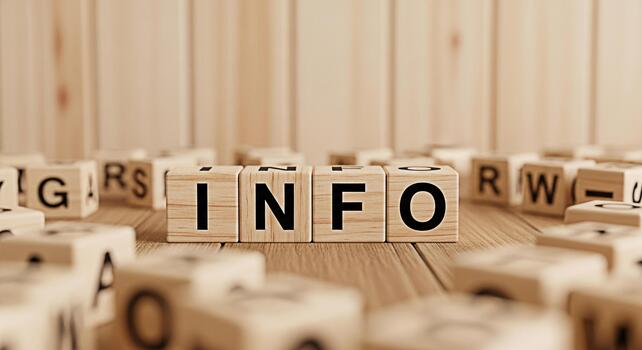 Wooden blocks spelling INFO on a wooden surface surrounded by other lettered blocks conveying a message of information and knowledge in a warm inviting and educational setting photo