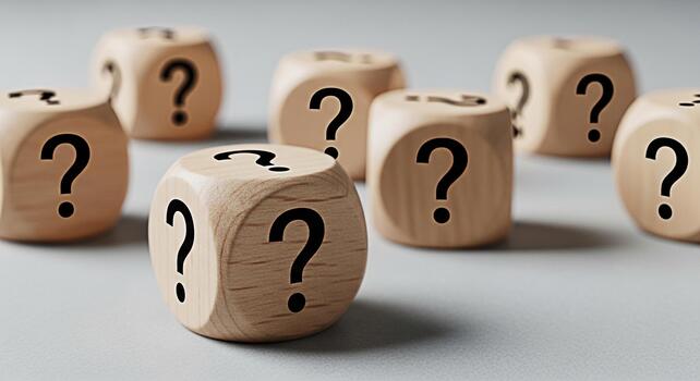 Group of wooden dice displaying question marks on a neutral surface representing uncertainty and decisionmaking in a business or educational setting creating a mood of curiosity and problemsolving photo