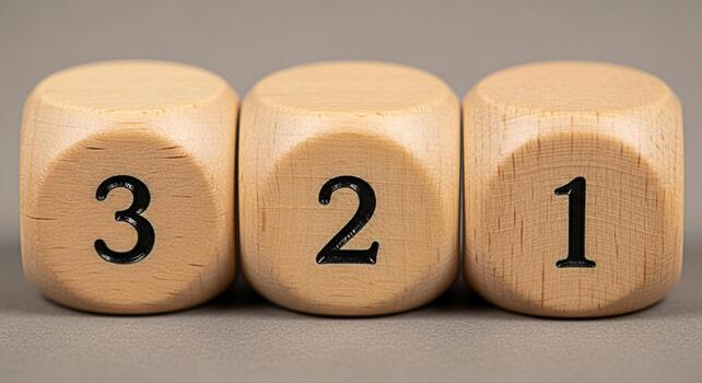 Three wooden dice displaying the numbers 3 2 and 1 on a gray surface suggesting countdown preparation and anticipation for a project event or game creating a sense of excitement and readiness photo