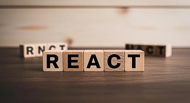 Wooden blocks spelling REACT on a wooden table representing the popular JavaScript library conveying a sense of modern web development and innovation in a simple clean and professional setting photo