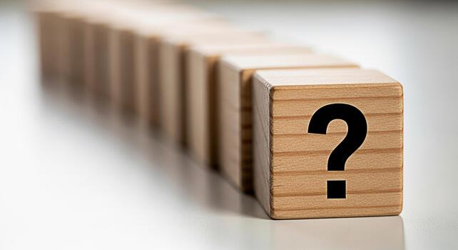 Wooden blocks displaying a question mark on a white surface representing uncertainty and the need for answers creating a sense of curiosity and problemsolving in a minimalist setting photo