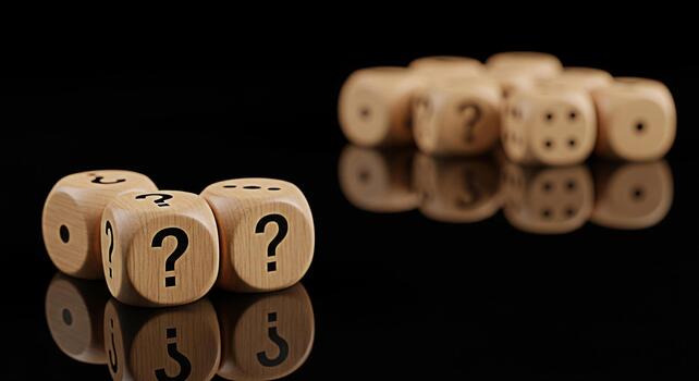 Wooden dice displaying question marks and numbers on a reflective black surface symbolizing uncertainty and chance in a game of strategy creating a mysterious and intriguing atmosphere photo