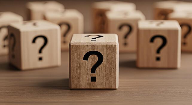 Wooden cubes displaying question marks on a wooden surface symbolizing uncertainty and the need for answers in a business or personal context creating a mood of inquiry and exploration photo