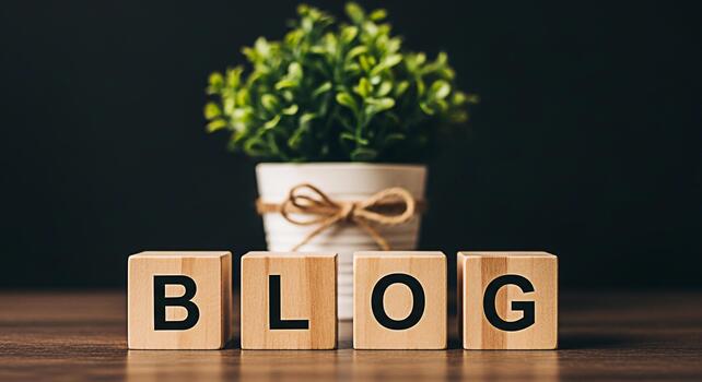 Wooden blocks spelling BLOG on a wooden table with a potted plant in the background creating a warm and inviting atmosphere for content creation and online writing perfect for blog promotion and marke photo