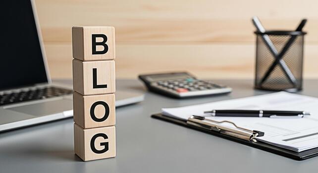 Wooden blocks spelling BLOG stand prominently on a gray office desk symbolizing online content creation and digital marketing strategies in a modern workspace fostering a sense of creativity and profe photo