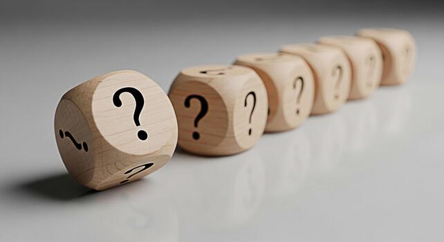 Wooden dice displaying question marks in a row on a white surface representing uncertainty and the search for answers in a clean and minimalist environment conveying a sense of curiosity and inquiry photo