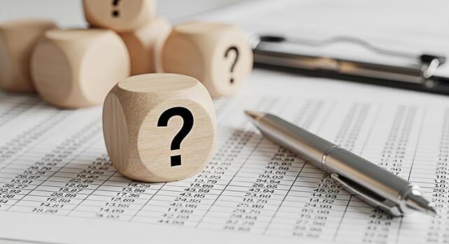Wooden dice with question mark on financial report symbolizing uncertainty and analysis in business creating a thoughtful and inquisitive atmosphere in a corporate setting financial planning concept photo