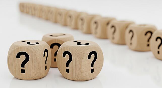 Wooden dice displaying question marks on a white surface symbolizing uncertainty and the need for problemsolving in business and life creating a sense of mystery and intrigue photo