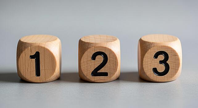 Three wooden dice displaying numbers in a sequence on a neutral surface representing counting steps and progress in a simple minimalist style with a focus on clarity and numerical order photo