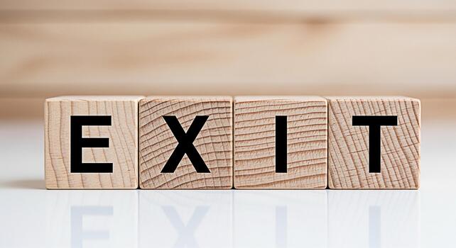 Wooden blocks spelling EXIT on a white surface representing a strategic decision in a business environment symbolizing a turning point and the concept of making a change or finding a solution photo