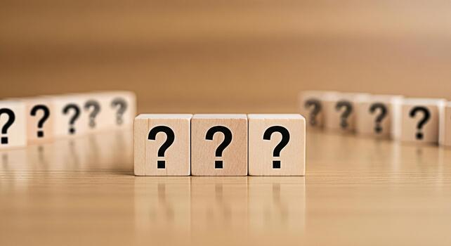 Wooden blocks displaying question marks on a wooden surface representing uncertainty and the search for answers in a business or personal context creating a sense of mystery and intrigue photo